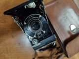 a brown leather case with a camera inside of it