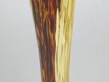 a yellow vase with a brown and white design on it