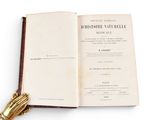 an open book with a gold hand on it