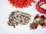 three pieces of jewelry on a white surface