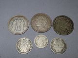 six different british coins sitting on top of a table next to a penny