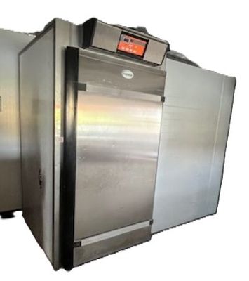 two stainless steel ovens sitting side by side on a white background