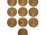 six gold sovereigns of various sizes and shapes on a white surface