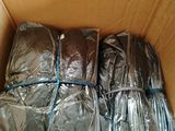 a cardboard box filled with wrapped blankets and blankets