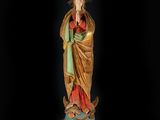 a statue of the virgin of guadalupe with a crown on her head