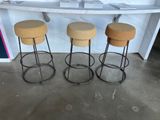 three stools are sitting in front of a counter in a room