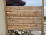a wooden fence that has been placed on the side of a building