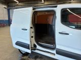 a white van with its doors open in a garage