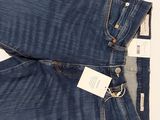 the back of a pair of blue jeans with a tag on it