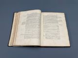an open book on a table with a blue background
