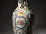 a vase with a design on it sitting on a table