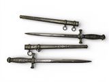 three different types of swords are displayed on a white surface