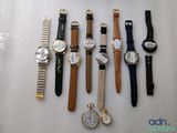 many different types of watches displayed on a table