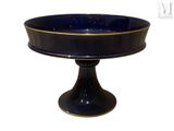 an image of a black and gold cake plate on a pedestal