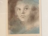 an old picture of a woman ' s face is shown in a white frame
