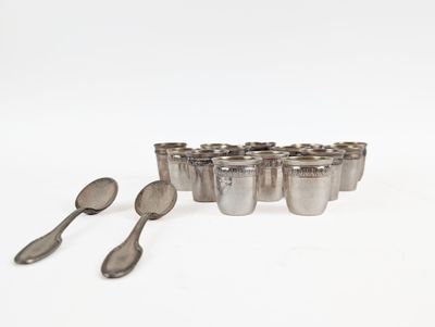 several spoons and spoon rest on a white surface next to a set of silver cups