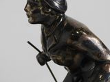statue of a man riding a horse on a wooden base