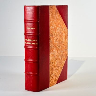 a red book sitting on a table with a white background