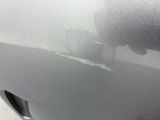 someone is peeling a car ' s paint on the side of the road
