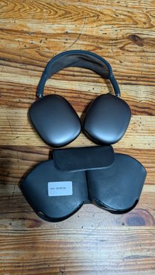 two black headphones sitting on top of each other on top of a wooden floor