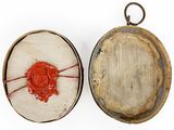 two pieces of wood with a red wax seal on them
