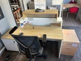 a desk with a chair and a computer on it