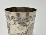 a silver cup with a number on it on a table