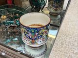 two cups on a glass table in front of a mirror