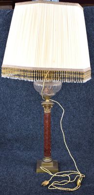 a lamp that is sitting on a table with a book on it
