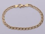 a gold chain bracelet with a heart clasp on a white background