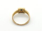 an image of a gold ring with a blue stone