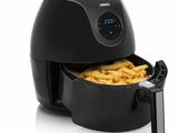 a black air fryer with french fries in it