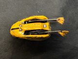 a yellow toy car that is sitting on a table