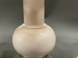 an image of a white lamp with a gold shade