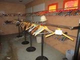 a lot of clothes hanging on a rack in a room