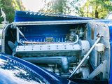 a close up of a car engine in the trunk of a blue car