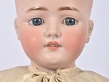 a small doll with a bow on it ' s head