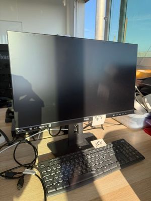 an image of a computer monitor and keyboard on a desk