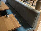 two tables and a bench in the corner of a restaurant