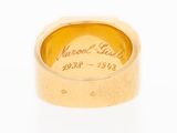 a close up of a gold ring with an inscription on it