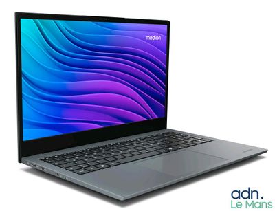 the laptop is open on a white surface with a blue background