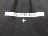 a picture of a label on a black shirt that says stone island