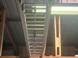 a ladder that is hanging from the ceiling in a garage