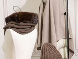 two hats and a scarf on a mannequin head