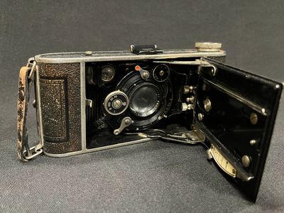 an old camera that is open on a table
