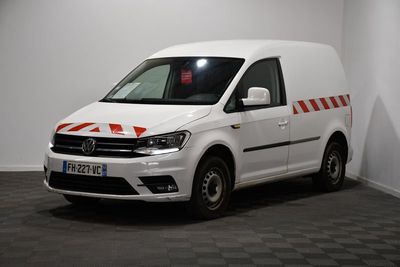 the white van is parked in a room with a checkered floor