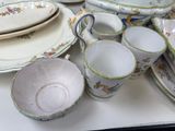 many plates and cups on the table together