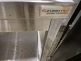 a dirty floor in a commercial kitchen with a dishwasher
