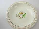 a white bowl with a picture of a house and trees on it