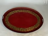 une image représentant un plateau rouge orné de motifs dorés